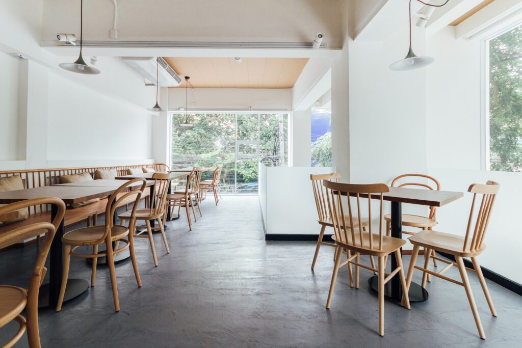 Minimal Bread Cafe Decorating With White Wall and Wooden Chairs